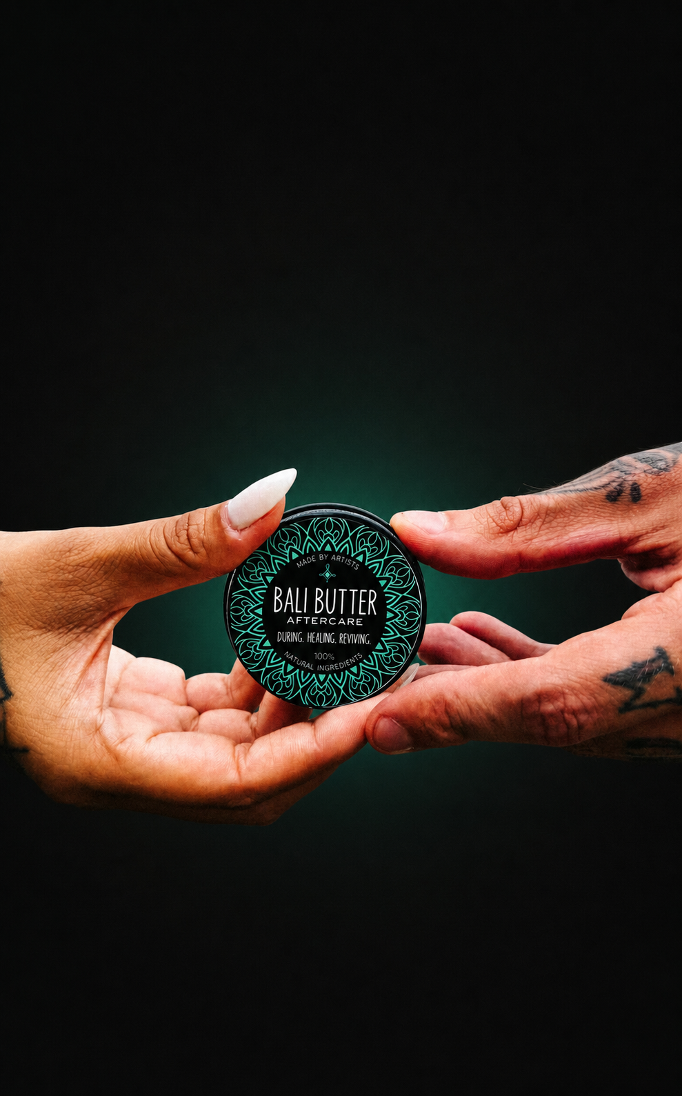 Bali Butter website concept hero featuring tattooed hands and the aftercare tin